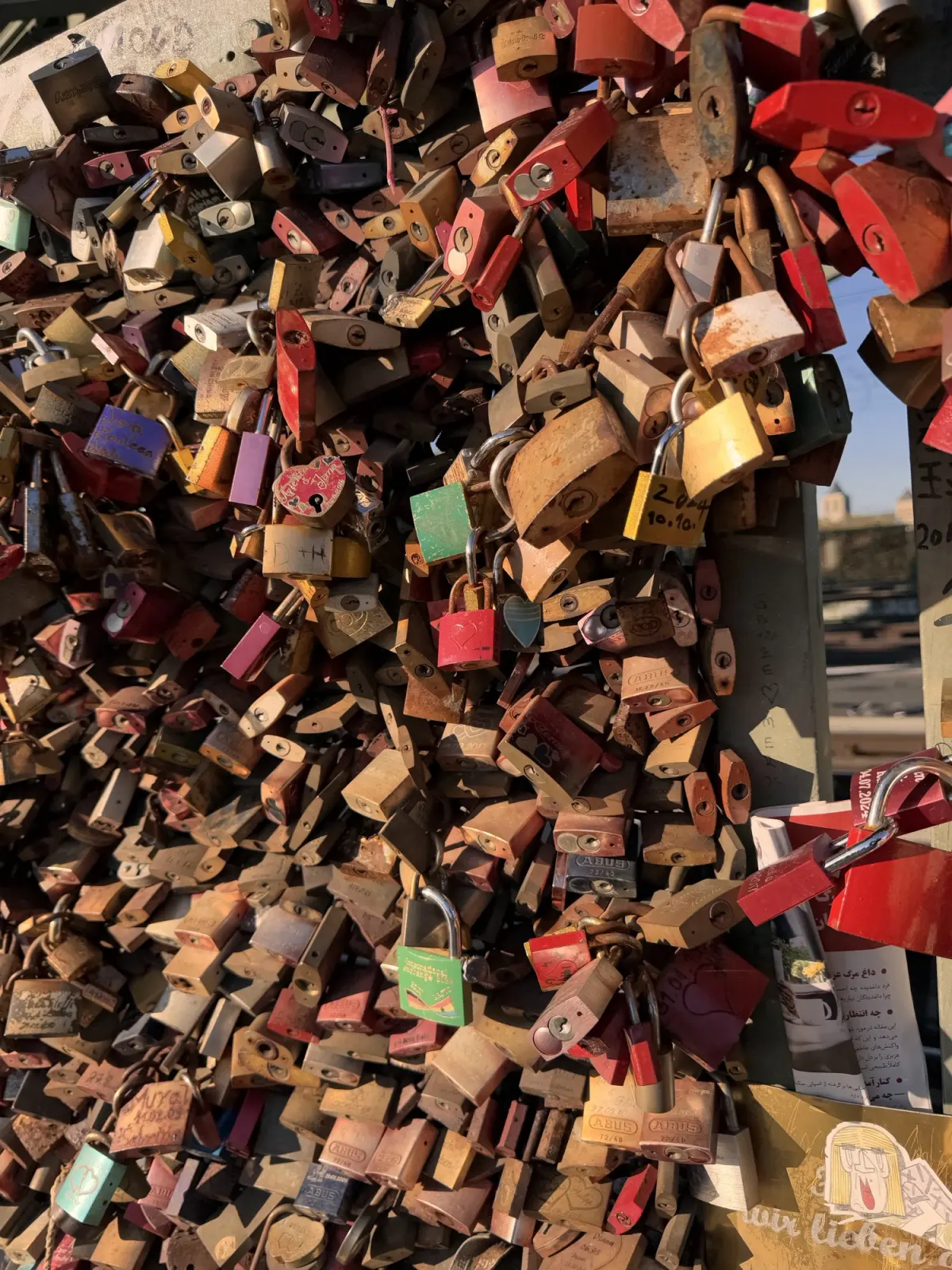 Padlocks layered several deep on the Hohenzollern Bridge railing