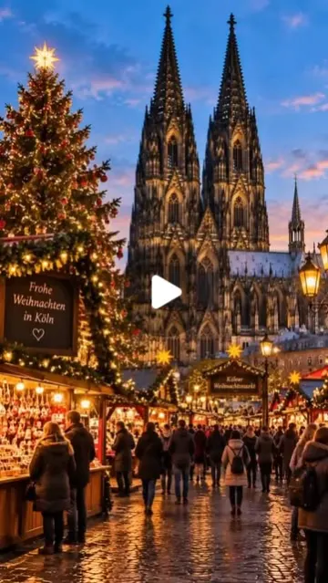 Christmas market stalls in front of Cologne Cathedral at dusk