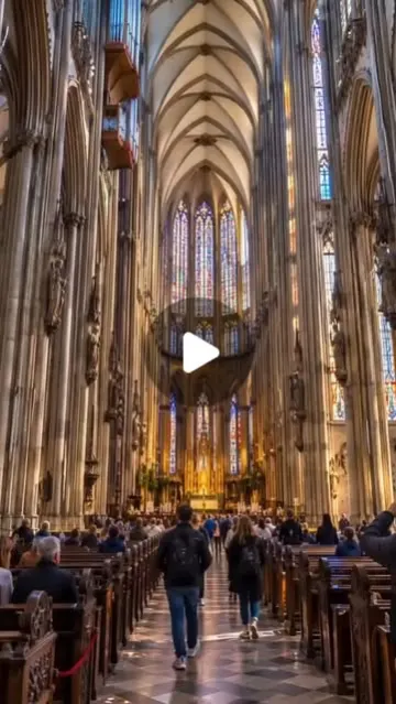 Visitors walking through the nave of Cologne Cathedral